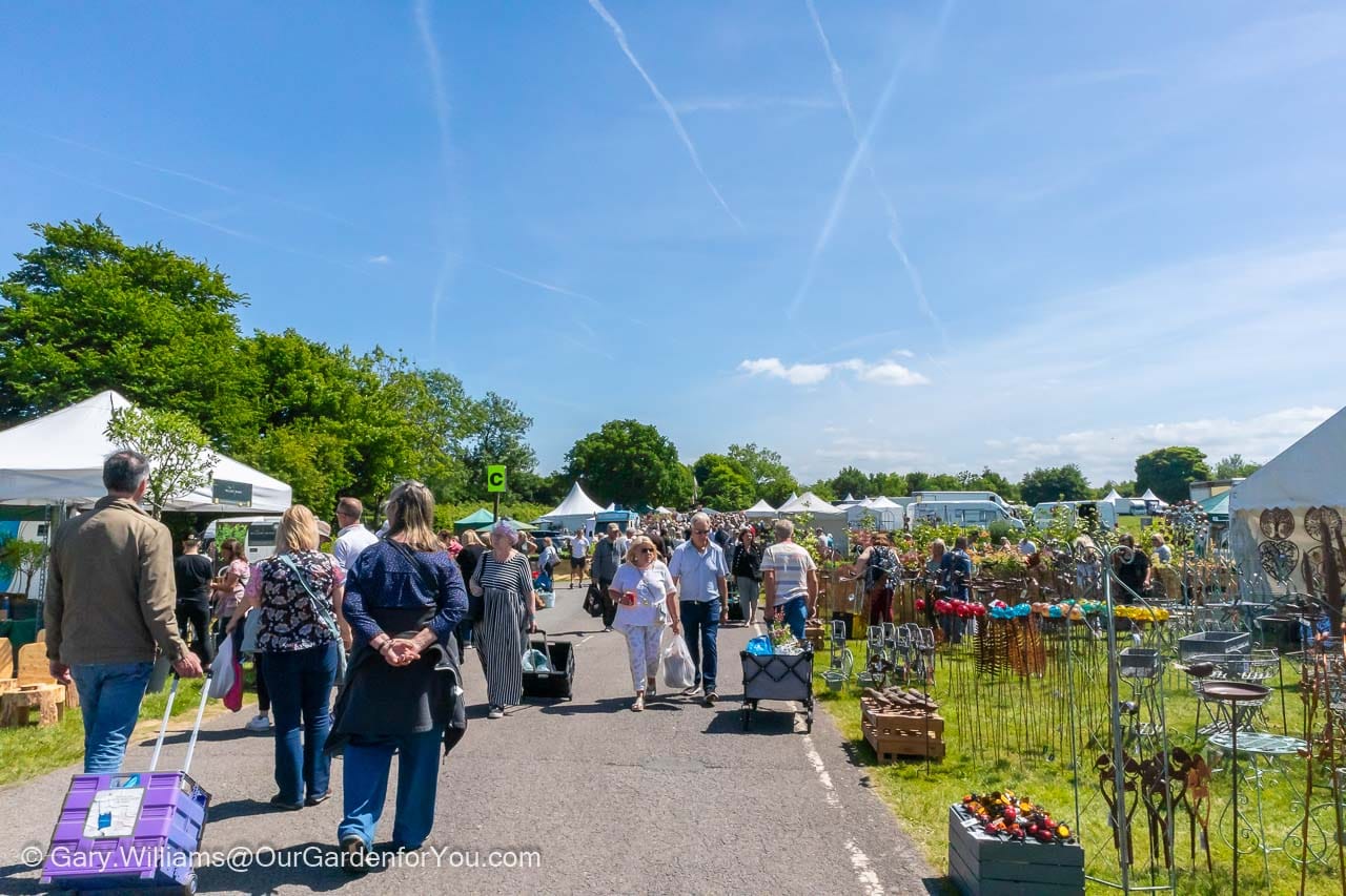 People walking along the main aisle at the Kent Garden Show