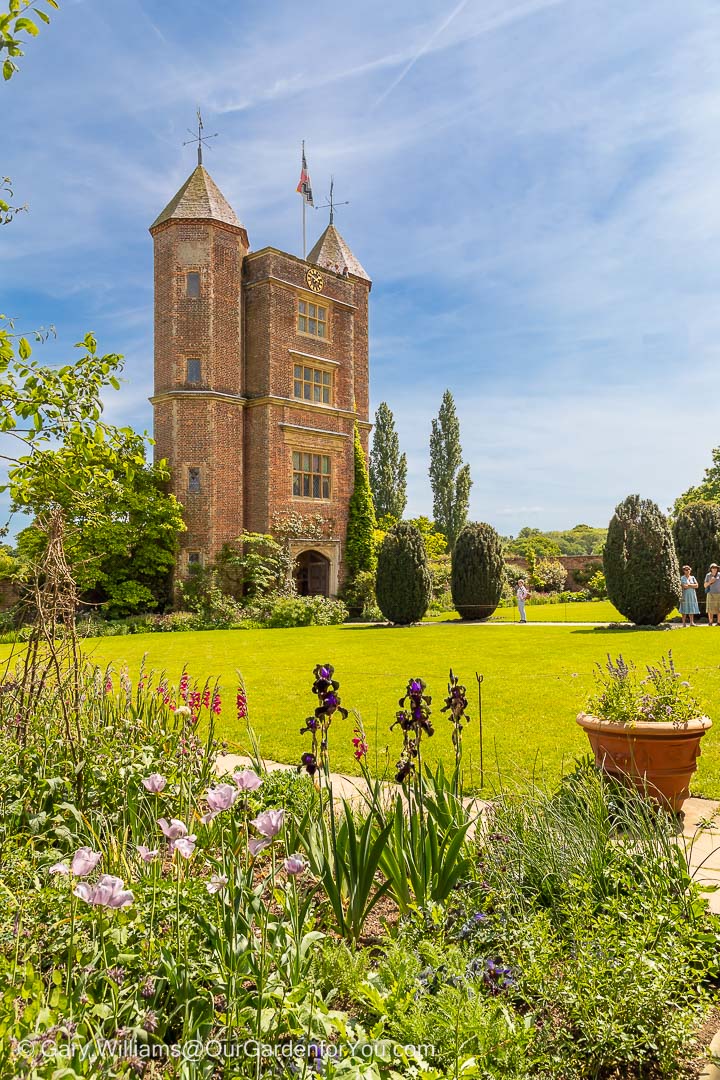 The twin turreted towers of Sissinghurst Castle set in beautifully manicured gardens