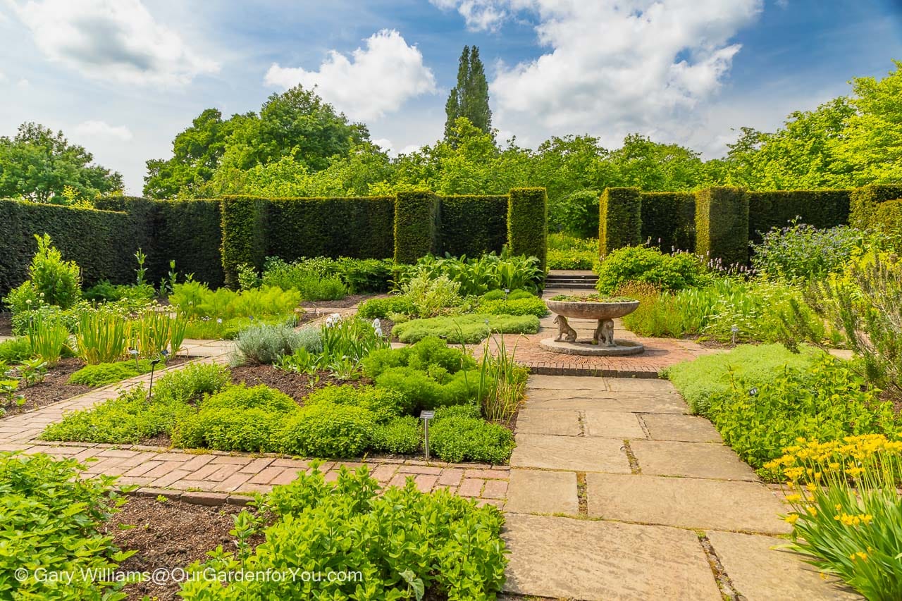 The formal square beds of the boxus lined herb garden at Sissinghurst Castle Garden