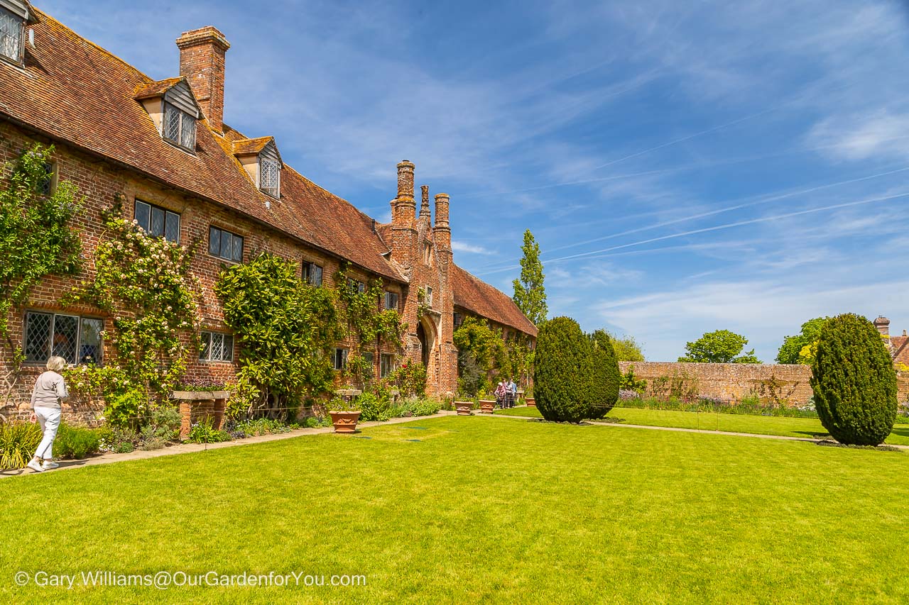 The top courtyard with its lush green lawns encased in the red-brick walls of the Sissinghurst Castle Gardens