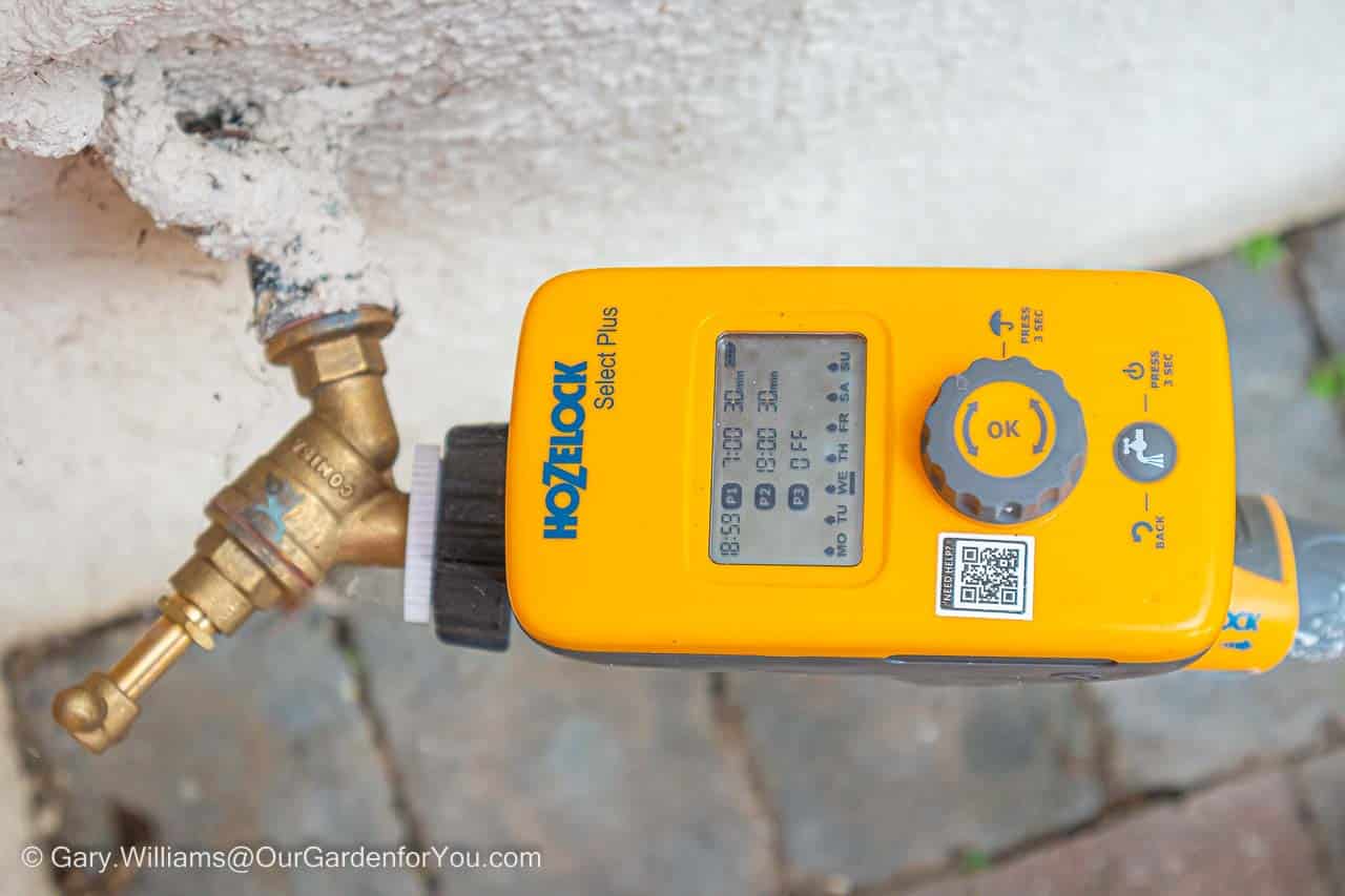 A Hozelock Select Plus electronic timer is attached to a brass external tap as part of our home irrigation system.