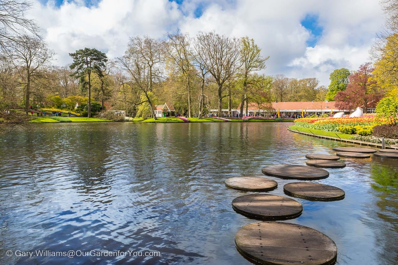 Stepping stones across the lake at keukenhof gardens in holland