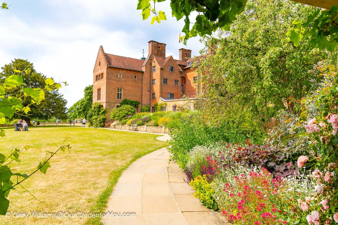 The rear view of the red-brick Chartwell House from the corner of the lawn in the marlborough pavilion