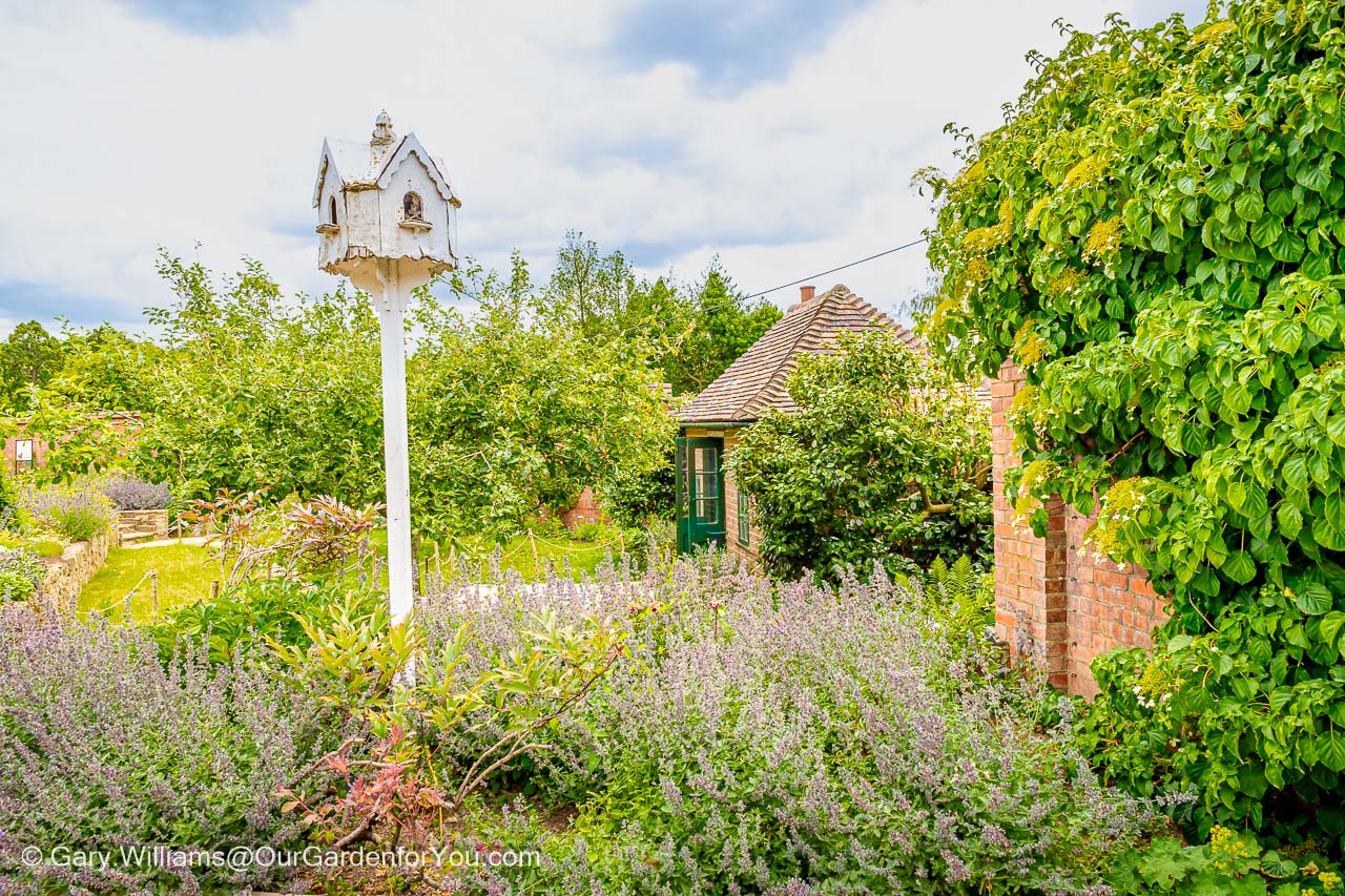 The white dovecote with the brick built marycot in the background within the walls of the walled garden in the chartwell estate in kent